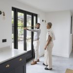 2 people measuring a Barrie door that will be replaced